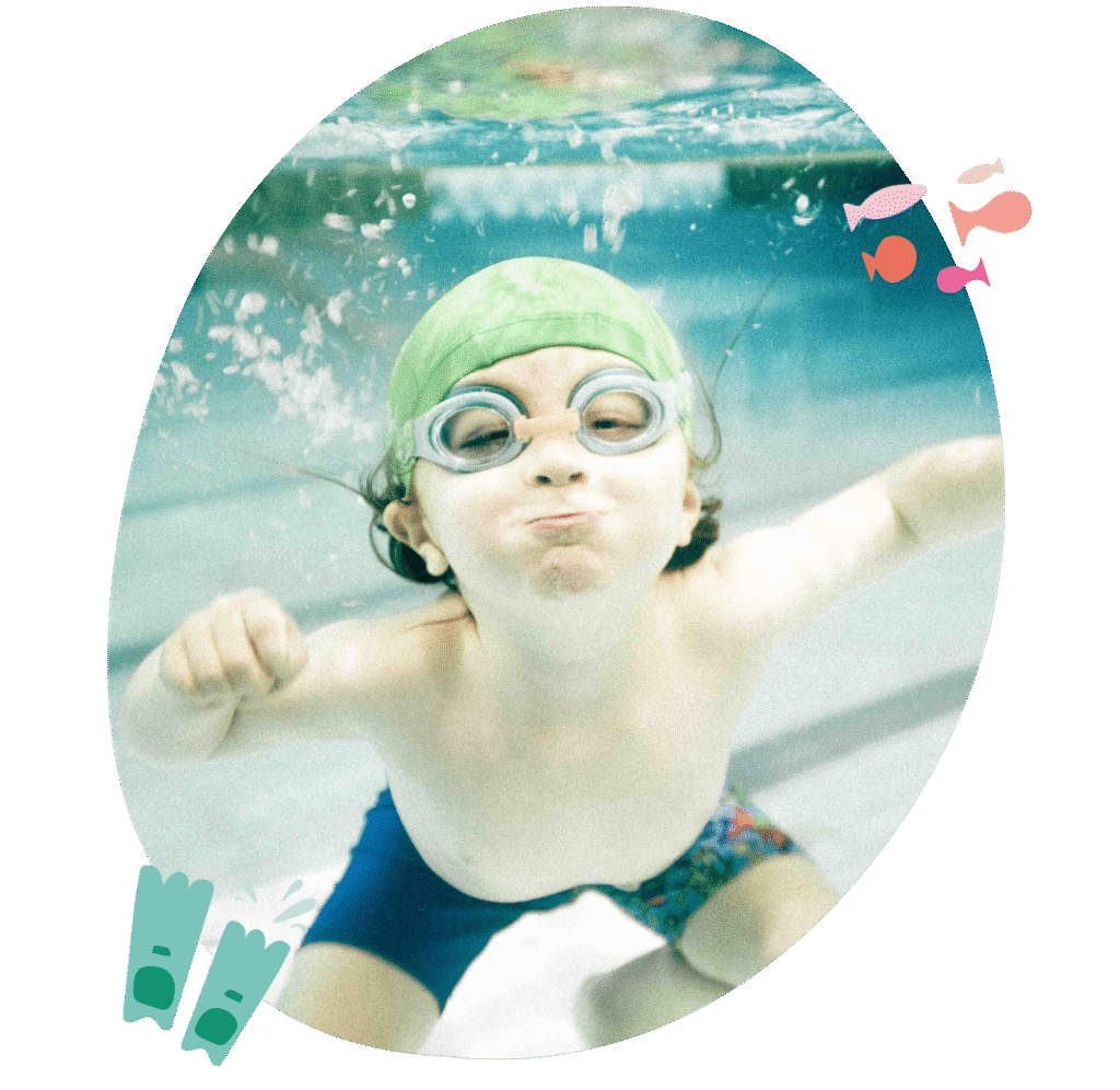 Child smiling in the pool during swimming lesson at In The Deep Swim School, Sydney